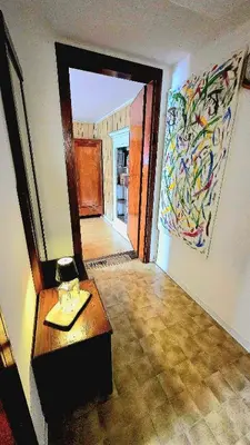 a room with a table and a painting on the wall at Maison Cavalese - Polar Express in Cavalese