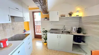 a small kitchen with white cabinets and a sink at Maison Cavalese - Polar Express in Cavalese