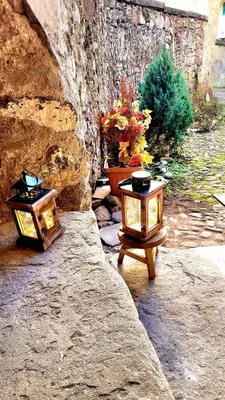 two lanterns sitting on a rock with a plant at Maison Cavalese - Polar Express in Cavalese