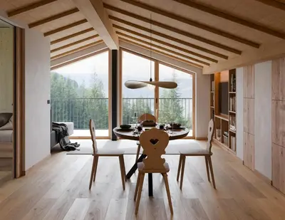 a dining room with a table and chairs and a large window at Gfohlerhof Brixen - Urlaub auf dem Bauernhof in Brixen