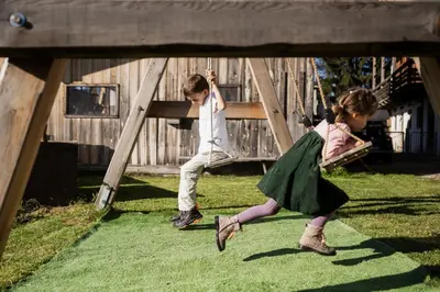 two young children playing on a swing set at Gfohlerhof Brixen - Urlaub auf dem Bauernhof in Brixen