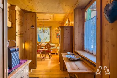 a wooden room with a table and a dining room at Suite Villa Francesca in Cortina dʼAmpezzo