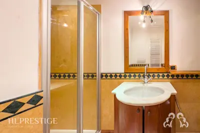 a bathroom with a sink and a shower at Suite Villa Francesca in Cortina dʼAmpezzo