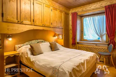 a bedroom with a bed and a window at Suite Villa Francesca in Cortina dʼAmpezzo