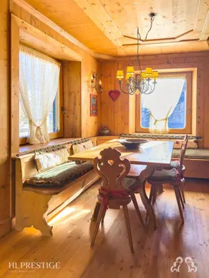 a dining room with a table in a log cabin at Suite Villa Francesca in Cortina dʼAmpezzo