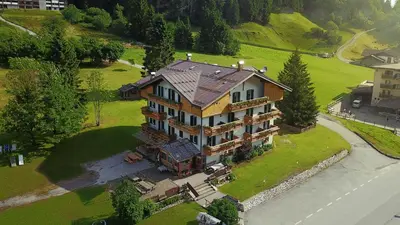 an overhead view of a large house on a green field at Rifugio Cereda - Dormitory in San Martino di Castrozza