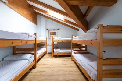 a room with a bunch of bunk beds at Rifugio Cereda - Dormitory in San Martino di Castrozza