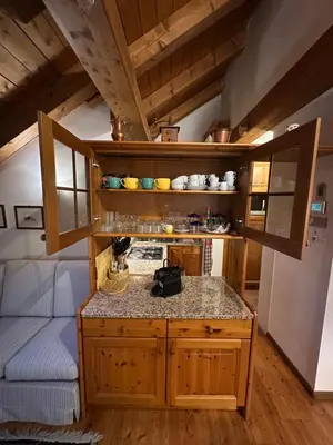 a kitchen with a counter in a room at Mansarda Ca' Fiori city center San Vito di Cadore in San Vito di Cadore
