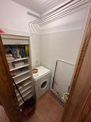a bathroom with a washing machine and a washer at Mansarda Ca' Fiori city center San Vito di Cadore in San Vito di Cadore