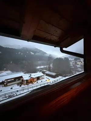 a view from a window of a house in the snow at Mansarda Ca' Fiori city center San Vito di Cadore in San Vito di Cadore