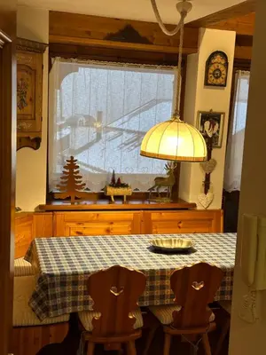a kitchen with a table with a checkered table cloth at Mansarda Ca' Fiori city center San Vito di Cadore in San Vito di Cadore
