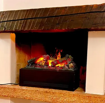 a brick fireplace with a fire in it at Cortina Relax in Cortina dʼAmpezzo