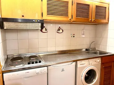 a kitchen with a stove and a dishwasher at Cortina Relax in Cortina dʼAmpezzo