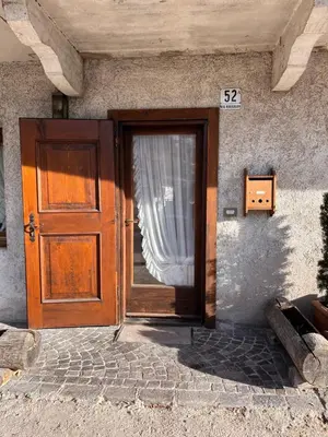 a door to a house with a sign on it at Cortina Relax in Cortina dʼAmpezzo