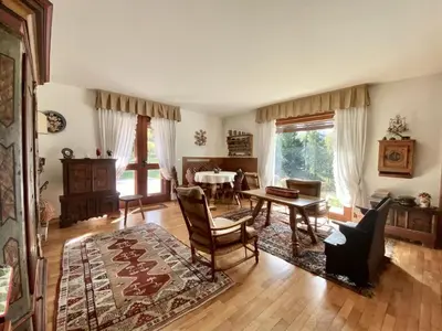 a living room with a table and chairs at Charming ground floor flat with mountain views in Cortina dʼAmpezzo
