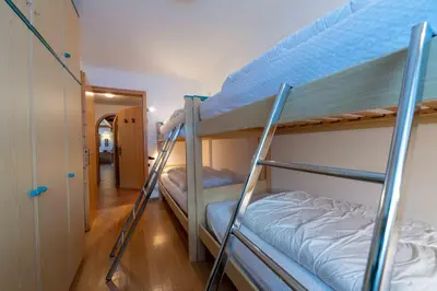 two bunk beds in a room with a hallway at Cesa Vivi in Canazei