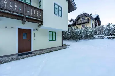 a yard covered in snow with a house at Cesa Vivi in Canazei