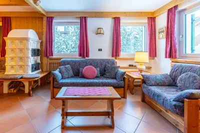 a living room with two couches and a table at Cesa Vivi in Canazei