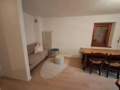 a living room with a couch and a table at La Casa di Elvira-Primo Piano in Alleghe
