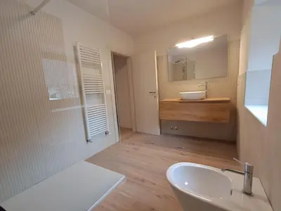 a bathroom with a sink and a toilet and a tub at La Casa di Elvira-Primo Piano in Alleghe