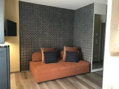 a couch with two pillows on it in a room at Masiere - La Chicca in Masarè