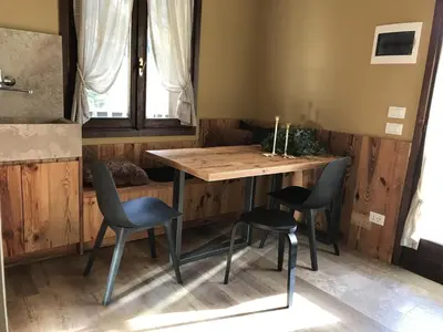 a table and chairs in a room with a window at Masiere - La Chicca in Masarè