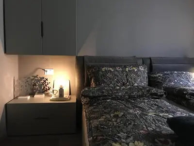 a bedroom with a bed and a nightstand with a lamp at Masiere - La Chicca in Masarè