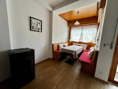 a small room with a table and a window at Da Benny in Caprile