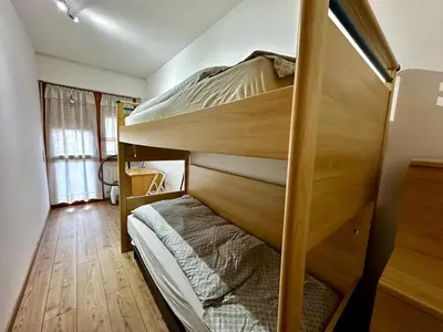 two bunk beds in a room with wooden floors at Da Benny in Caprile