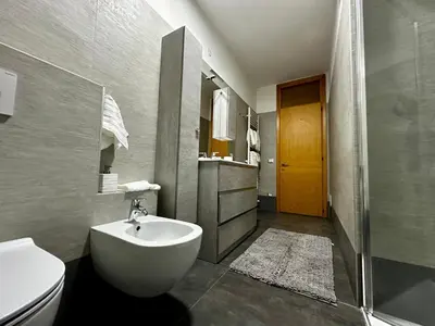 a bathroom with a white toilet and a sink at Da Benny in Caprile