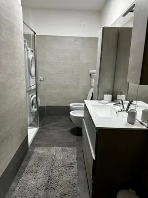 a bathroom with a sink and a toilet and a mirror at Da Benny in Caprile