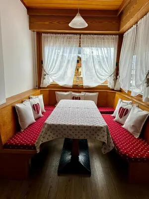 a dining room with a table and a window at Da Benny in Caprile