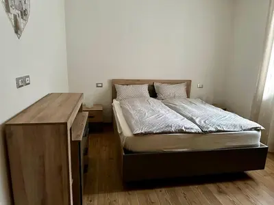 a bedroom with a bed and a wooden table at Da Benny in Caprile