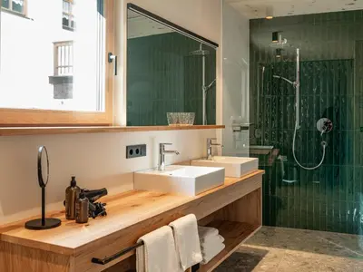 a bathroom with a sink and a shower at Kreithner luxury apartments in Vandoies