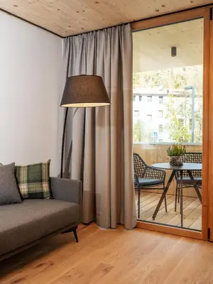 a living room with a couch and a table at Kreithner luxury apartments in Vandoies