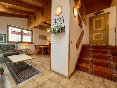 a living room with a couch and a table at L'Antico Fienile - Val di Fiemme in Daiano