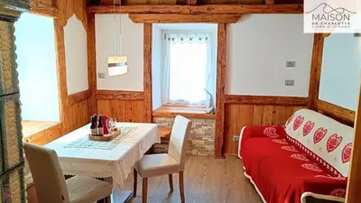 a bedroom with a bed with towels and a mirror at La Maison de Charlotte - Val di Fiemme in Ziano di Fiemme