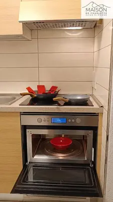 a kitchen with a sink and a counter top with a cutting board at La Maison de Charlotte - Val di Fiemme in Ziano di Fiemme