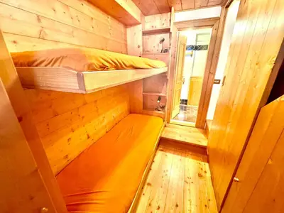 a small room with a bunk bed and a window at Cozy Apartment - Alverà in Cortina dʼAmpezzo