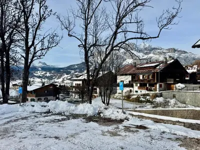 a village in the snow with houses and trees at Cozy Apartment - Alverà in Cortina dʼAmpezzo