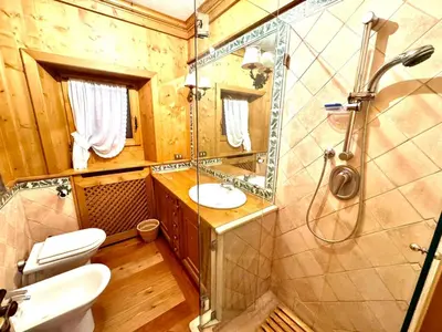 a bathroom with a toilet and a sink and a shower at Ca Montagni - High-end apartment Verocai in Cortina dʼAmpezzo