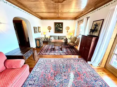a living room with a couch and a rug at Ca Montagni - High-end apartment Verocai in Cortina dʼAmpezzo