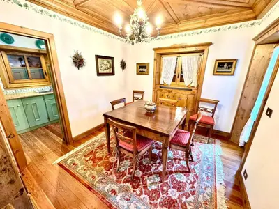 a dining room with a wooden table and chairs at Ca Montagni - High-end apartment Verocai in Cortina dʼAmpezzo