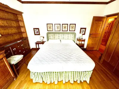 a bedroom with a large bed in a room at Ca Montagni - High-end apartment Verocai in Cortina dʼAmpezzo