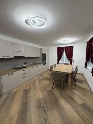 a kitchen and dining room with a table and chairs at Chalet La Viola in Alba di Canazei