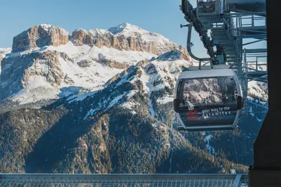 a ski lift in front of a snow covered mountain at Chalet La Viola in Alba di Canazei