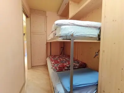 a small room with three bunk beds in it at Apartment Appartamento Ghezzi by Interhome in Campitello