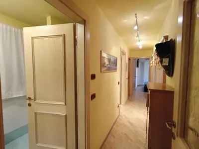 a hallway with a white door and a room at Apartment Appartamento Ghezzi by Interhome in Campitello