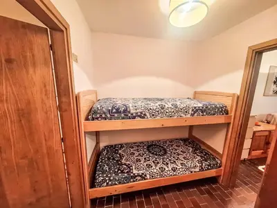 a room with two bunk beds in a room at Apartment Appartamento Matilde by Interhome in Penia