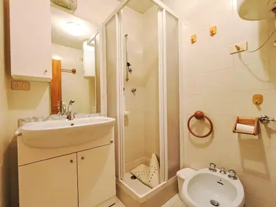 a bathroom with a sink and a shower and a toilet at Apartment Appartamento Matilde by Interhome in Penia
